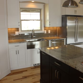 Canterbury Floor and Home - a kitchen with white cabinets and stainless steel appliances - Flooring Near Me - Manhattan, Kansas Canterbury Floor and Home - a kitchen with white cabinets and stainless steel appliances - Flooring Near Me - Manhattan, Kansas