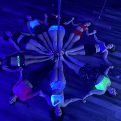 Studio X Vertical Fitness - Group photo from a private black light pole party.