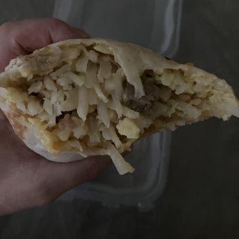 Biscuits Cafe - a hand holding a half eaten pastry - Cafes Near Me - Oregon City, Oregon