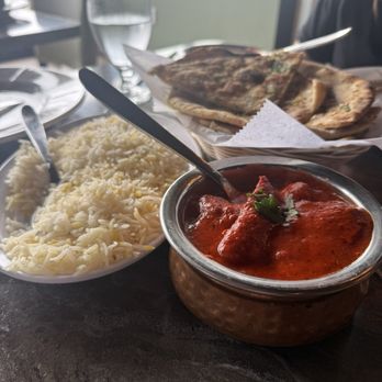 Blu Basil - This is their version of butter, chicken, and of course, some garlic naan. - Indian Near Me - Chagrin Falls, Ohio