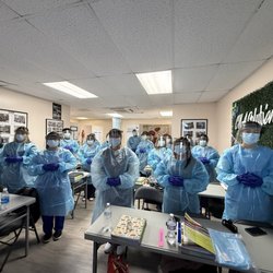 CNA Solutions Center - Learning how to wear full PPE properly = group photo moment!