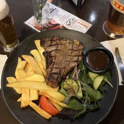 Maloney's Hotel - 350g T-bone Steak with Chips, Salad and gravy sauce.