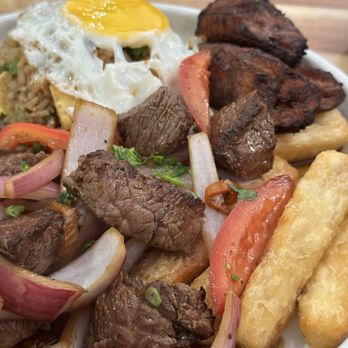 Don Cha Peruvian Food - Lomo Saltado a Lo Pobre, I substituted the papa fritas for yucca fritas and the white rice for chaufa. - Peruvian Near Me - Fort Walton Beach, Florida Don Cha Peruvian Food - Lomo Saltado a Lo Pobre, I substituted the papa fritas for yucca fritas and the white rice for chaufa. - Peruvian Near Me - Fort Walton Beach, Florida
