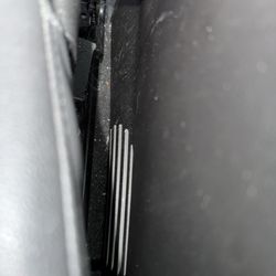 Between front passenger seat and center console.
