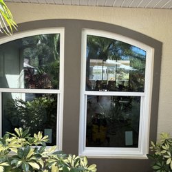 Gulf Coast Windows And Doors - White vinyl PGT single hung windows with architectural top