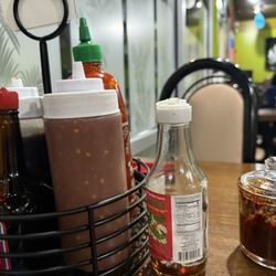 Kim Phuong - Good variety of condiments. The hot sauces are good and like that they have fish sauce too.