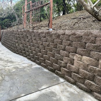 Erick’s Landscaping - Final wall, you can see the angle and how far the hill needed to be pushed back - Landscaping Near Me