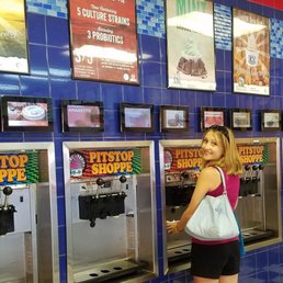 a woman standing in front of a machine a woman standing in front of a machine