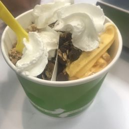 a green cup filled with yogurt a green cup filled with yogurt