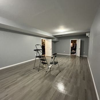 Stringa Enterprise Construction - empty room with hard wood floors - Painters Near Me