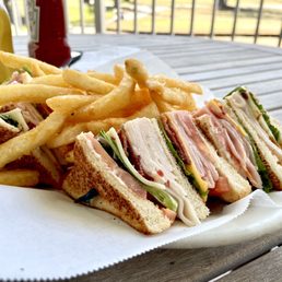a club sandwich and fries a club sandwich and fries