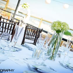 A Flower Snob - Simple yet elegant centerpieces made with green hydrangea and beargrass inside the glass.