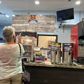 Five Brothers Two - a man and a woman standing in front of a soda machine - Cuban Near Me - Summerland Key, Florida