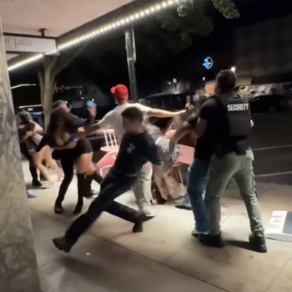 Security trying to separate girls fighting Security trying to separate girls fighting