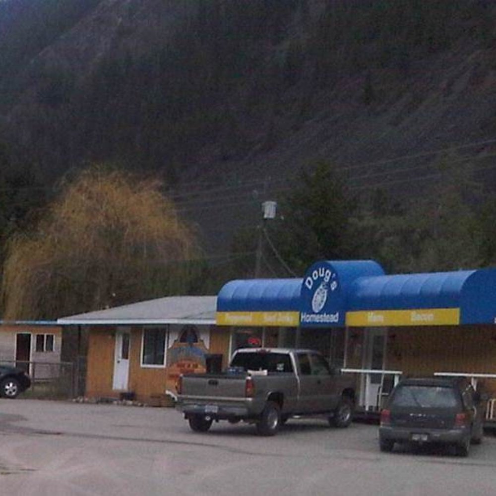 Doug's Homestead - a gas station with cars parked in front of it - Meat Shops Near Me - Kaleden, British Columbia