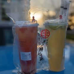 Shuyi Tealicious - Watermelon crush (no sugar and less ice) and fresh lime iced tea (less sugar and ice) teas with the sun setting. Both are large.
