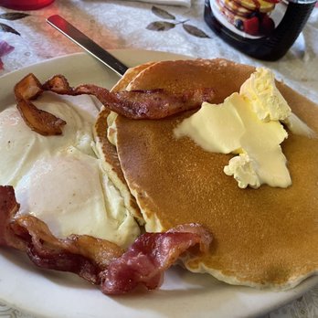 Arturo's Cafe - Two large and fluffy pancakes topped with butter. 2 eggs. 2 strips of bacon. - Cafes Near Me - San Antonio, Texas Arturo's Cafe - Two large and fluffy pancakes topped with butter. 2 eggs. 2 strips of bacon. - Cafes Near Me - San Antonio, Texas