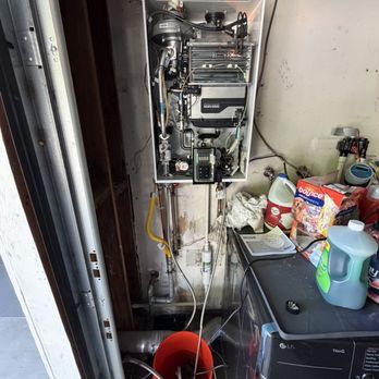 Campbell Plumbing and Rooter - At work cleaning out the tankless unit - Plumbing Near Me