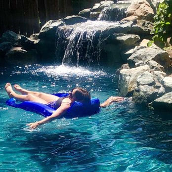 Advanced Pools - a woman floating in a pool - General Contractors Near Me - Rancho Cordova, California