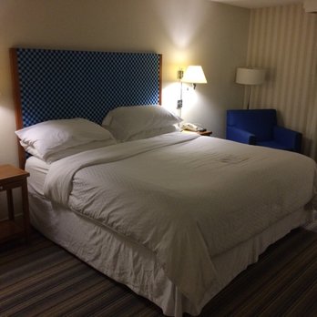 Four Points by Sheraton Bakersfield - King bed with chair in corner - Hotels Near Me - Bakersfield, California