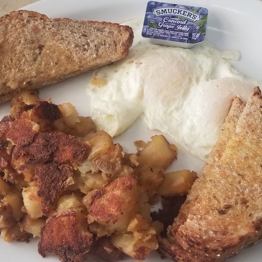 Eggs over easy with hash browns and toast