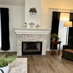 Flaherty's Flooring America - Cypress - 'After' photo of new living room floor and fireplace stone.  Philadelphia (stone) and Cambridge Oak in Natural (floor tile).