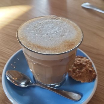 Bluestone Lane - Vanilla Oatmilk Latte with tiny cookie. - Coffee & Tea Near Me - Orange, California Bluestone Lane - Vanilla Oatmilk Latte with tiny cookie. - Coffee & Tea Near Me - Orange, California