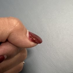Tip Top Nails - The corner of my nail overlaps the nail bed.