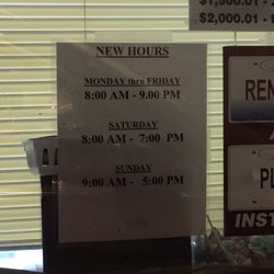 Lawrence Ashland Currency Exchange - The sign at the drive-through window showing their hours, which they do not honor.