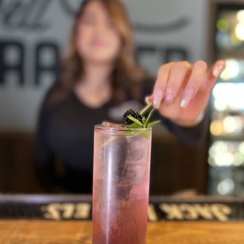 The Brass Tap - a woman putting a garnish on a drink - Beer Bar Near Me - Corona, California The Brass Tap - a woman putting a garnish on a drink - Beer Bar Near Me - Corona, California