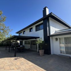 Top Quality Painting - Front entrance of a modern home with white paint and black trim.