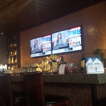 Watts Restaurant - a bar with a large screen tv - British Near Me - Toronto, Ontario Watts Restaurant - a bar with a large screen tv - British Near Me - Toronto, Ontario