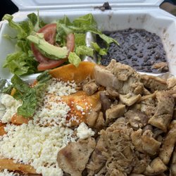 Lolita La Tampiqueña - Enchiladas with chicken. Black beans and rice is under the chicken.