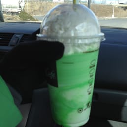 a green drink in a plastic cup