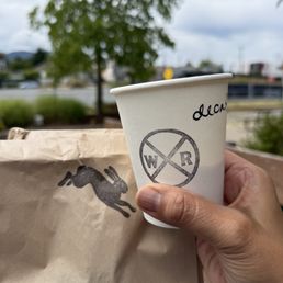 Decaf oat milk machiatto and two vegan /gluten free baked goods: donut and pecan bar. Decaf oat milk machiatto and two vegan /gluten free baked goods: donut and pecan bar.