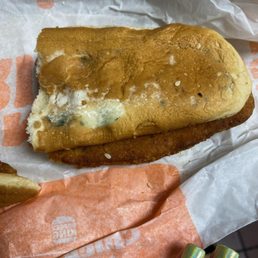 a hand holding a half eaten sandwich a hand holding a half eaten sandwich