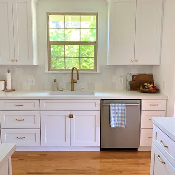 Corbin DeLapp Builders - a kitchen with white cabinets and wood floors - General Contractors Near Me
