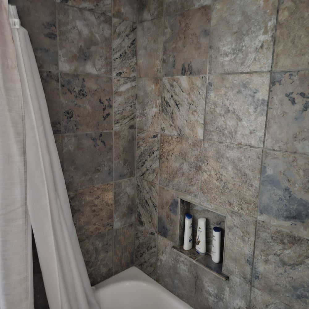 Diamond Design & Construction - a bathtub and shower curtain - General Contractors Near Me - Lawton, Oklahoma Diamond Design & Construction - a bathtub and shower curtain - General Contractors Near Me - Lawton, Oklahoma