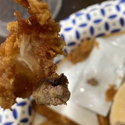 a piece of fried chicken on a fork a piece of fried chicken on a fork