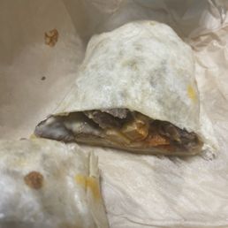 Grilled cheese burrito, extra steak and fries in the burrito