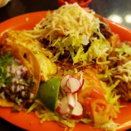 Combo plate steak taco, cheese enchilada and Al pastor tostada with all the trimmings. Combo plate steak taco, cheese enchilada and Al pastor tostada with all the trimmings.