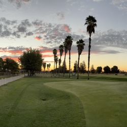 Pheasant Run Golf Club - Panorama view of the putting green, the club house, and a morning sunrise.