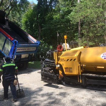 Briggs Paving - a man standing in front of a dump truck - General Contractors Near Me - Poughkeepsie, New York Briggs Paving - a man standing in front of a dump truck - General Contractors Near Me - Poughkeepsie, New York