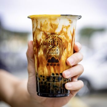 Tiger Sugar - a hand holding a cup of iced coffee - Bubble Tea Near Me - Westminster, Colorado Tiger Sugar - a hand holding a cup of iced coffee - Bubble Tea Near Me - Westminster, Colorado