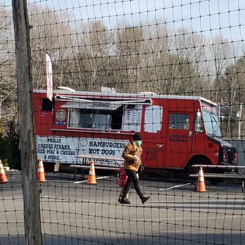 Road Grub Mobile - a man walking past a food truck - Food Trucks Near Me