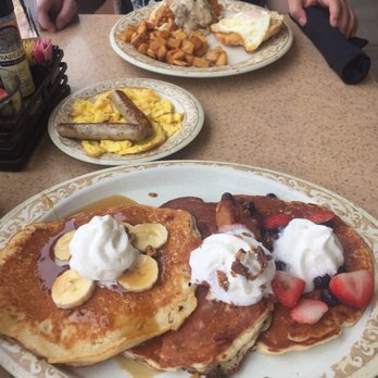 Another Broken Egg Cafe - Pancake trio! Left to right: banana fosters, peach cobbler, and mixed berries. I opted for scrambled eggs and turkey sausage for sides - Breakfast & Brunch Near Me - Clearwater, Florida