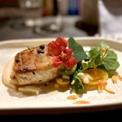 The Lost Kitchen - Butter basted halibut on top of pomme purée, heirloom baby tomatoes, capers, nasturtiums and sweet corn.