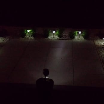 Smith Landscaping - a person sitting on a patio at night - Landscaping Near Me