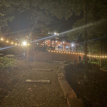 Bravo Cabin Rentals - Back yard at night facing the cabin from the creek sitting area! - Vacation Rentals Near Me - Broken Bow, Oklahoma Bravo Cabin Rentals - Back yard at night facing the cabin from the creek sitting area! - Vacation Rentals Near Me - Broken Bow, Oklahoma
