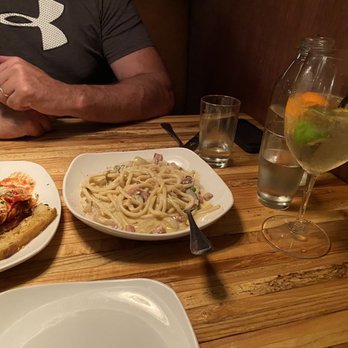 Cello Italian Restaurant - a man sitting at a table with a plate of pasta and a glass of wine - Italian Near Me - Howell, Michigan Cello Italian Restaurant - a man sitting at a table with a plate of pasta and a glass of wine - Italian Near Me - Howell, Michigan